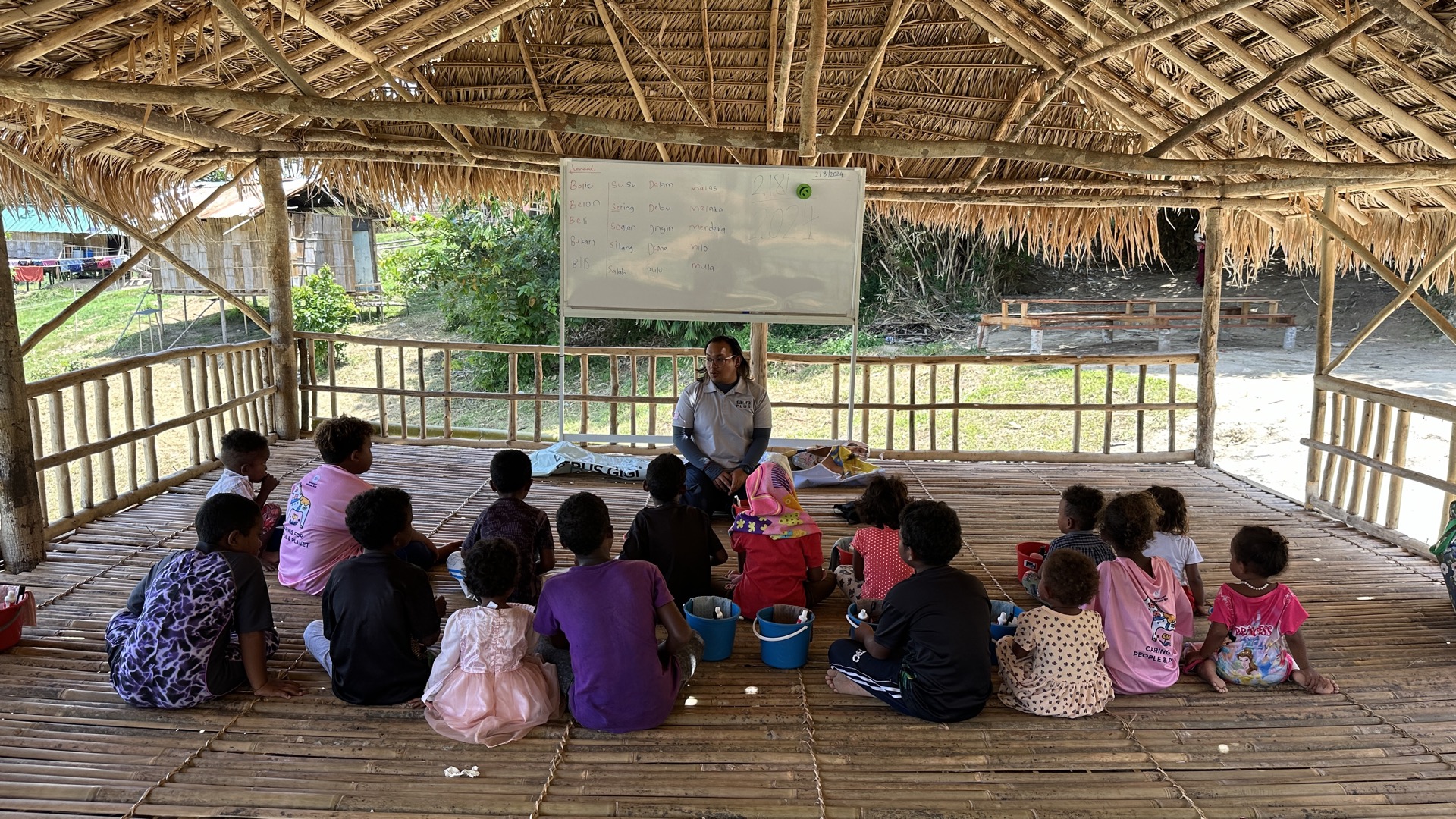 Orang Asli students proudly displaying their schoolwork and achievements at a Saora+ education programme event