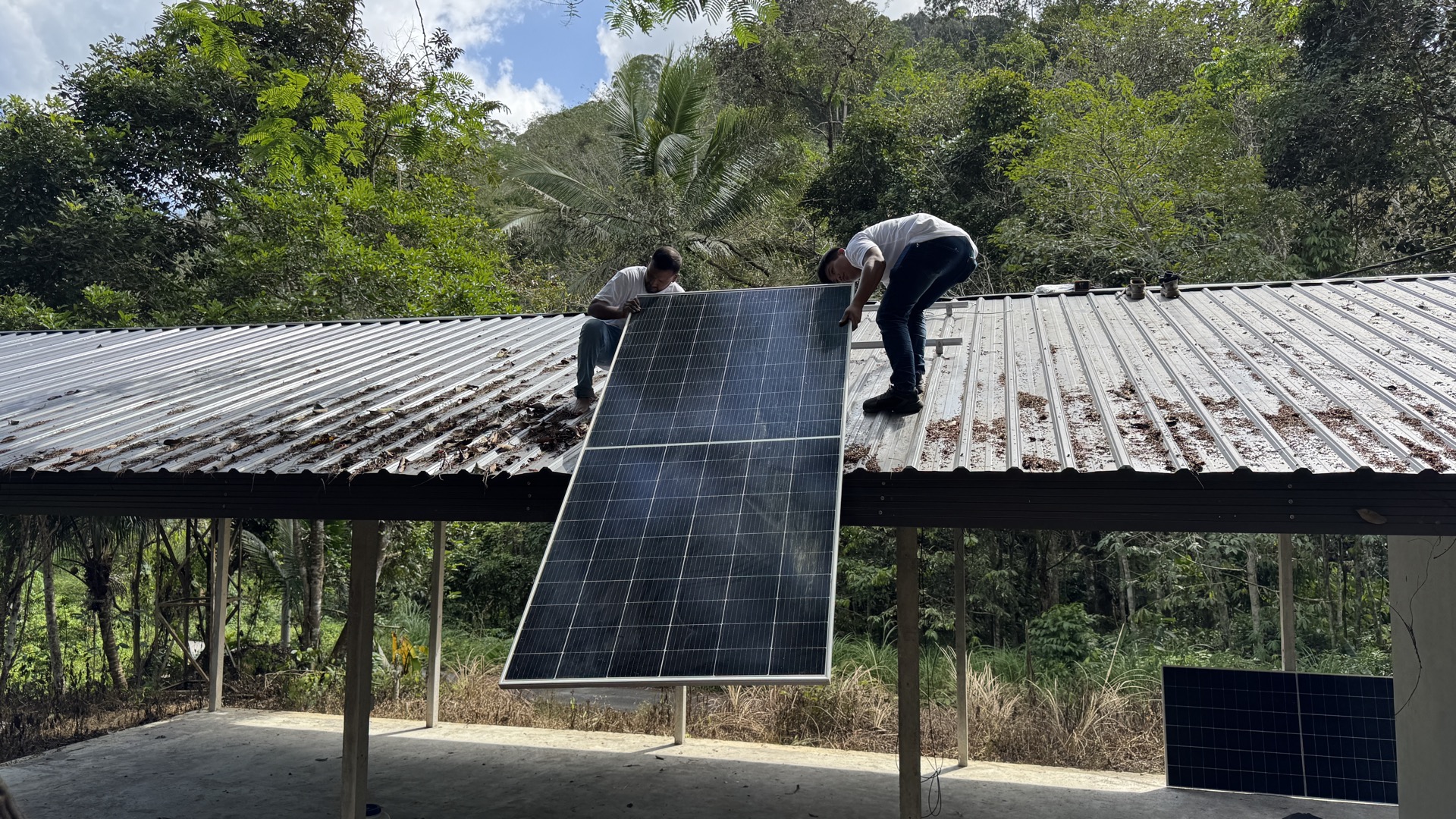 Inside the solar-powered communal hall at Sungai Kelit — community space illuminated by off-grid solar energy