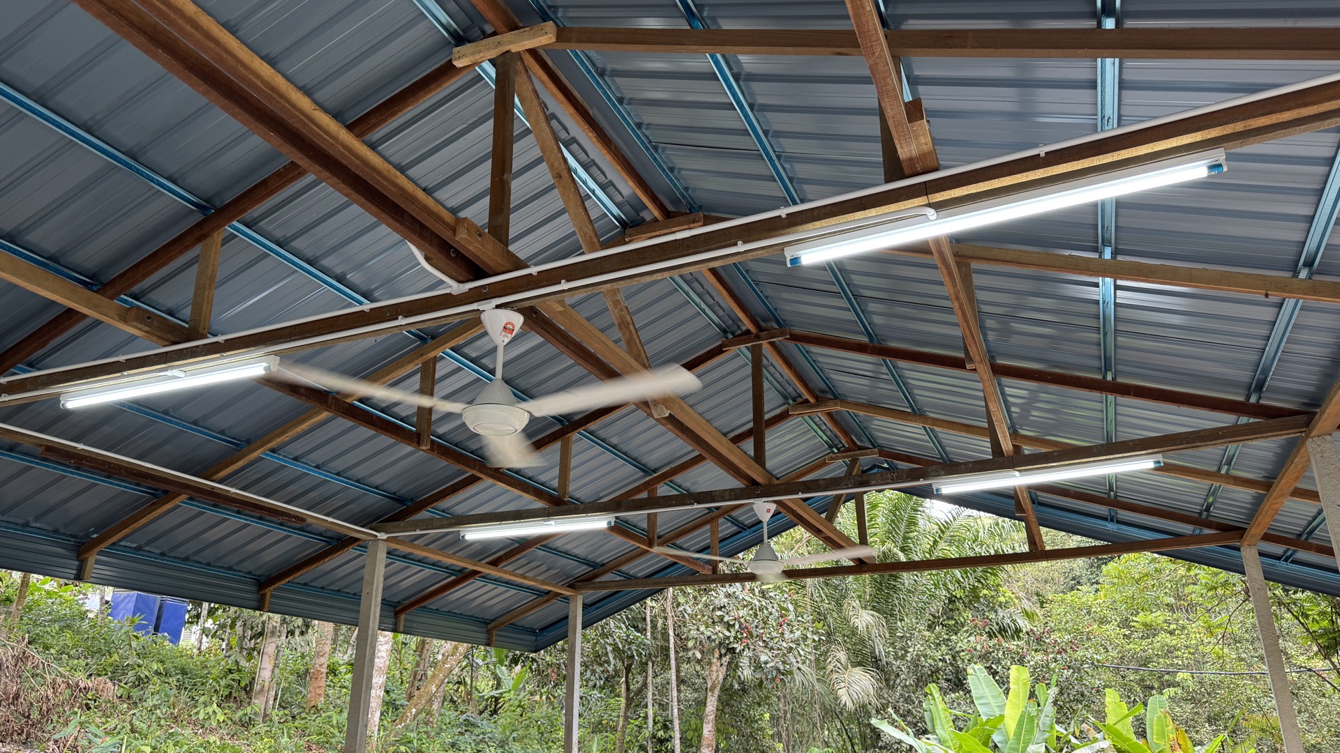 Saora+ solar infrastructure at Sungai Kelit — rooftop solar panel array and electrical system powering the communal hall