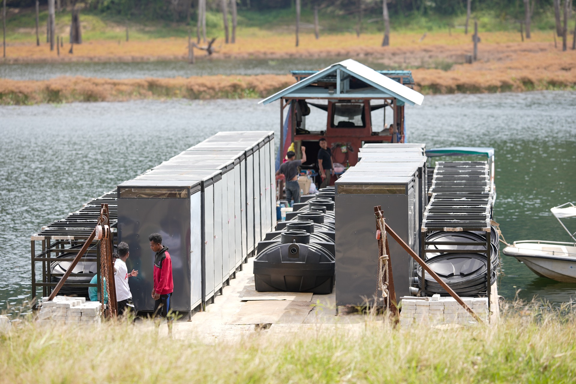 Saora+ team conducting a WaSH hygiene education workshop with Orang Asli families under a communal shelter